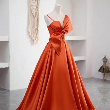 Elegant Orange Satin Gown With Sculptural Bow..